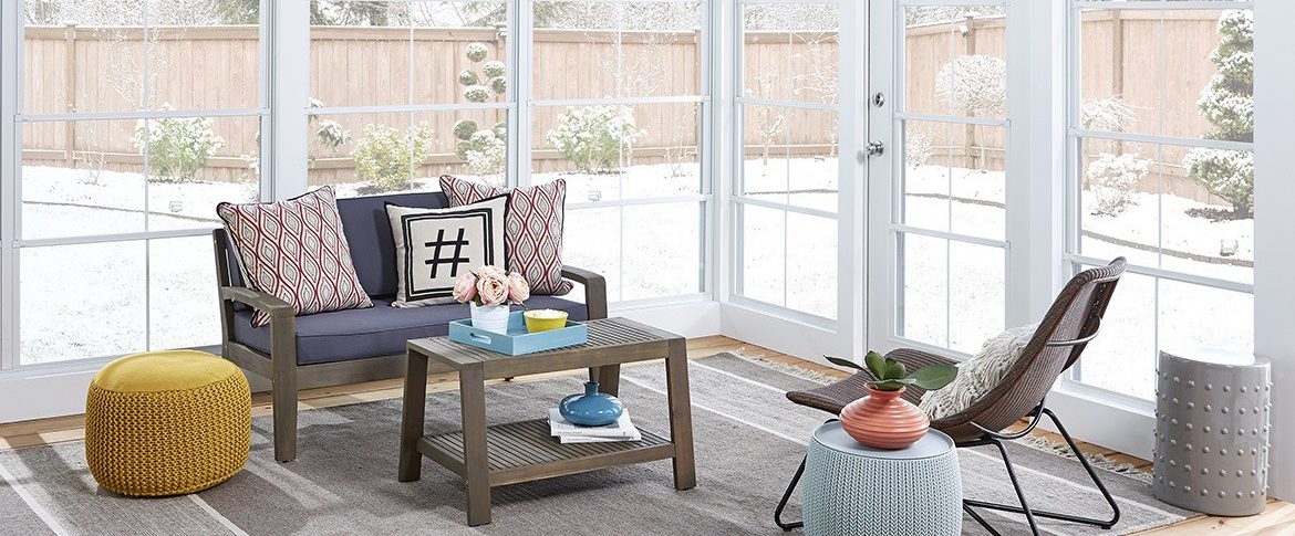 Outdoor living space in Eze-Breeze porch enclosure after snowfall.