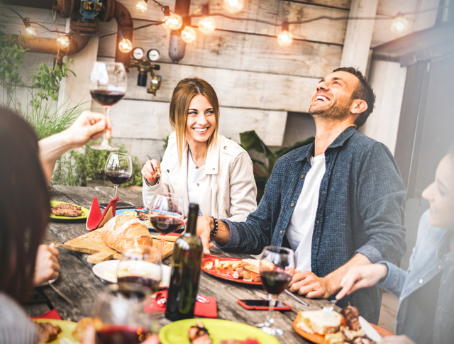 Friends spend time together having dinner outdoors