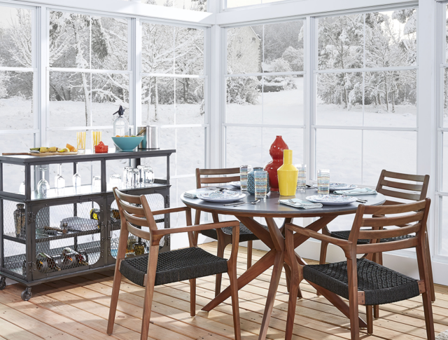 Four season room being as a dining area to enjoy the winter landscape